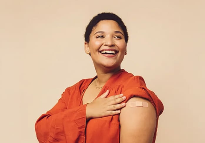 a person sitting with a bandaid on their arm