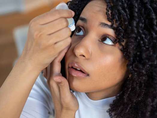 Person using eye drops